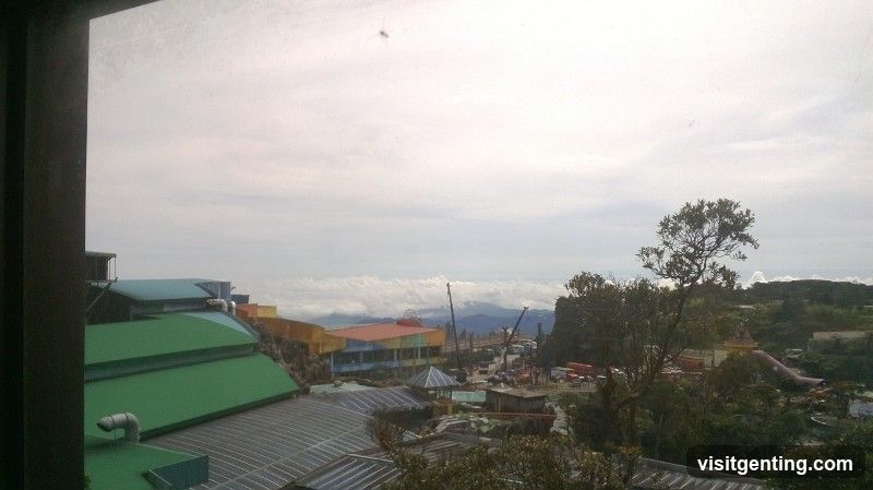 View from a window overlooking an amusement park area