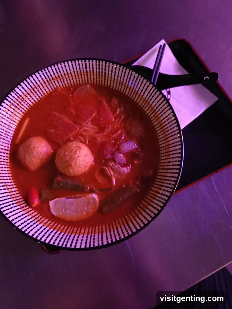 Bowl of Red Soup with Meatballs and Lime
