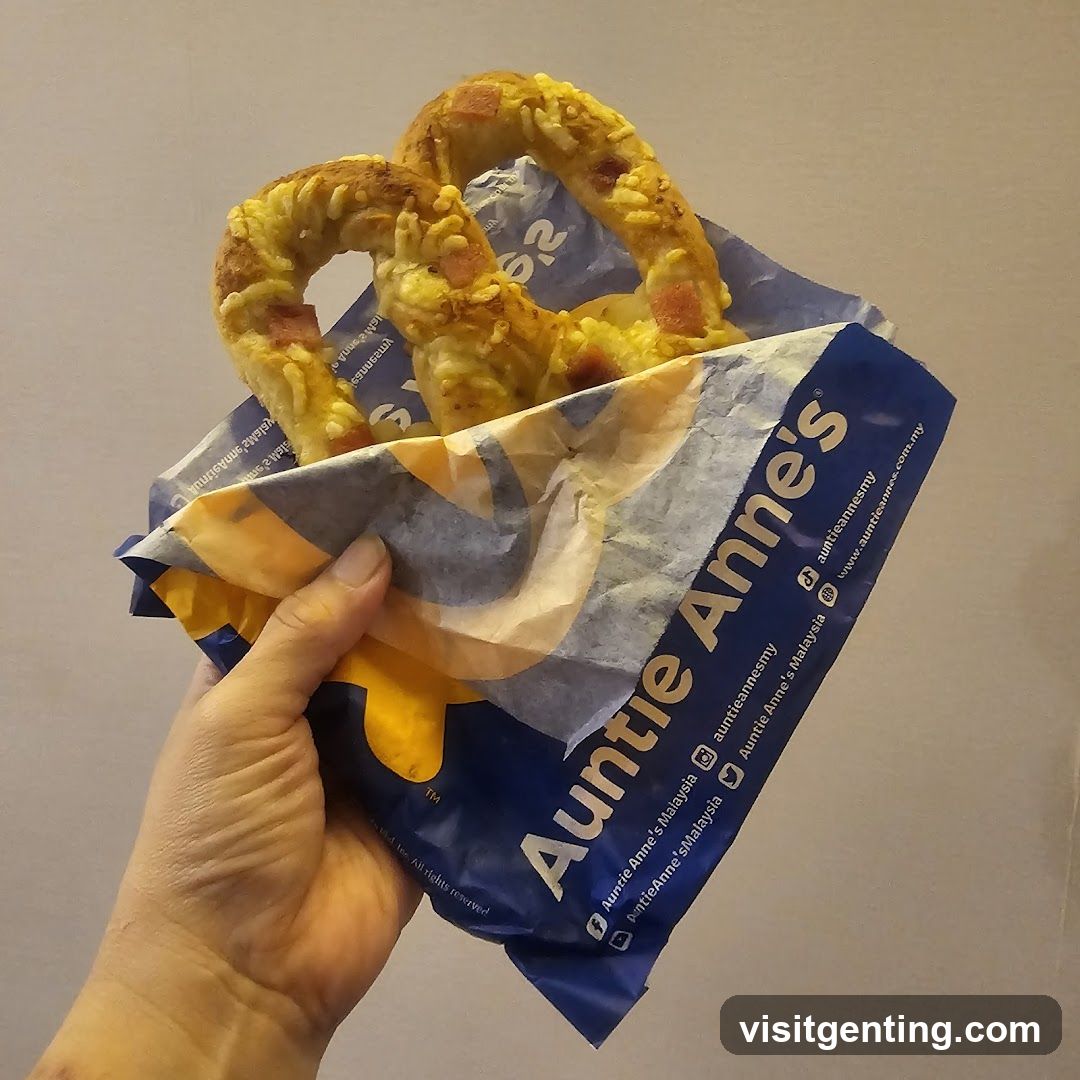 Hand holding Auntie Anne's pretzel