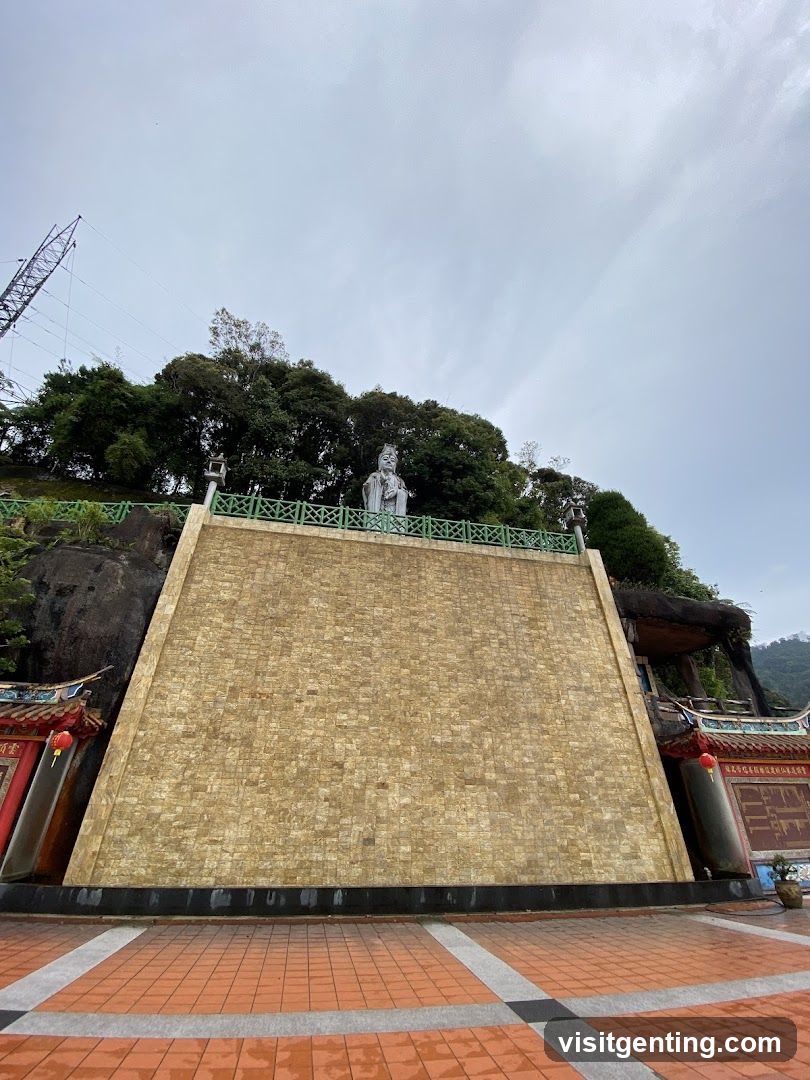 Temple Complex with Statues and Stone Wall