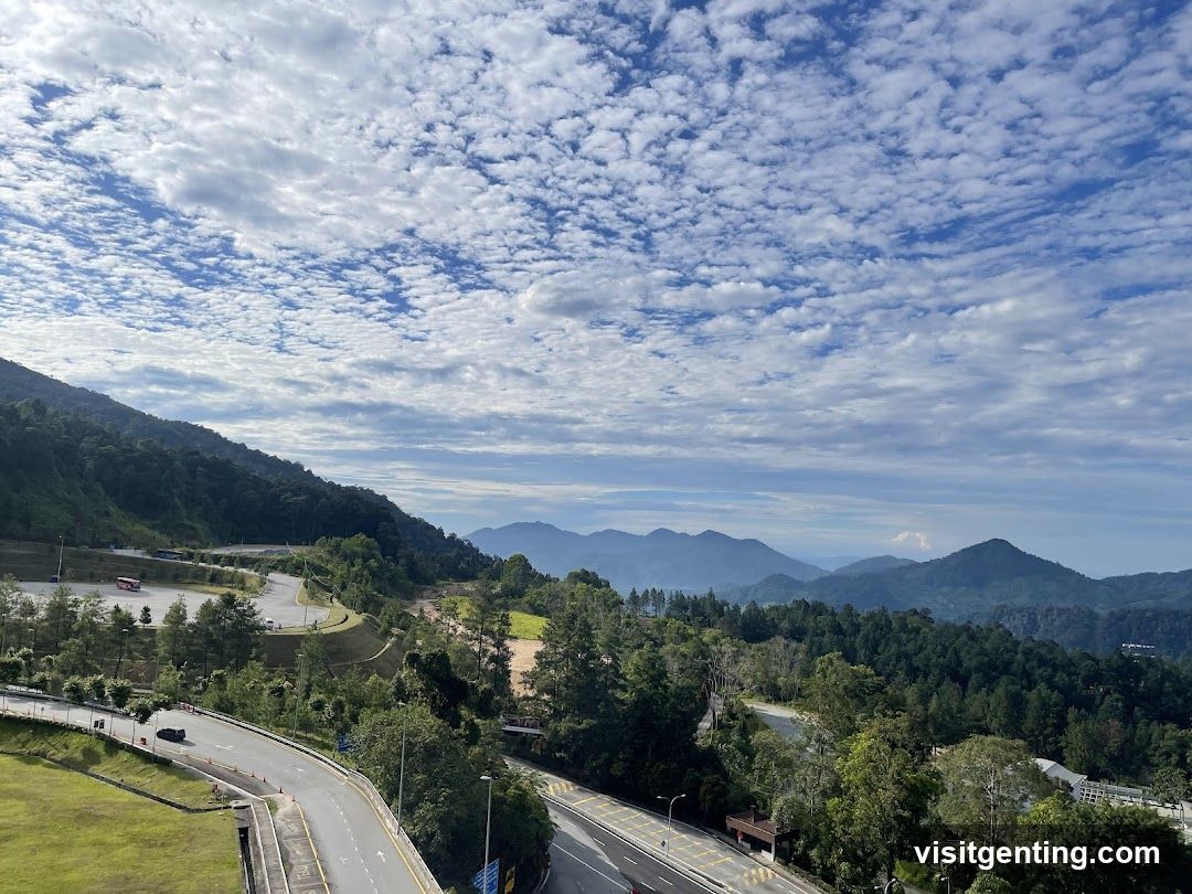 Mountainous Landscape with Road and Cloudy Sky
