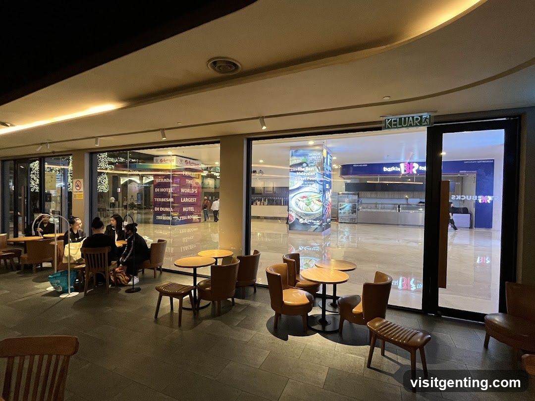 Interior seating area with glass doors leading to a shopping mall
