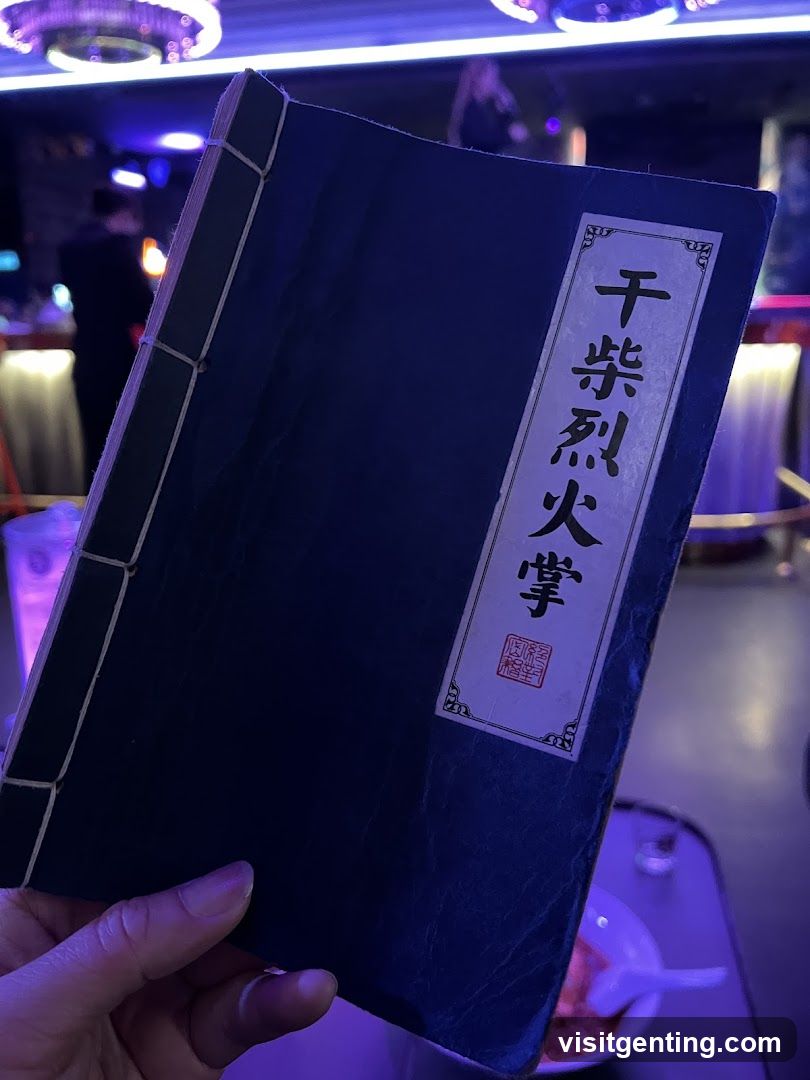 Hand holding a book in dimly lit venue