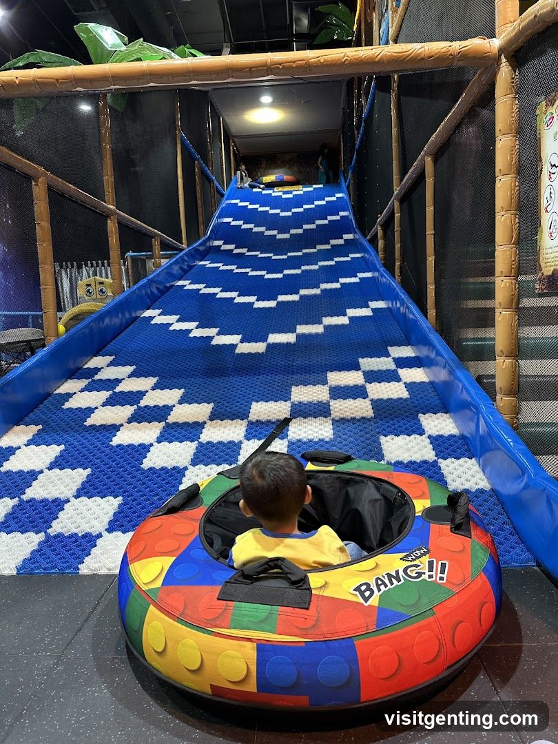 Child on inflatable tube at indoor play area
