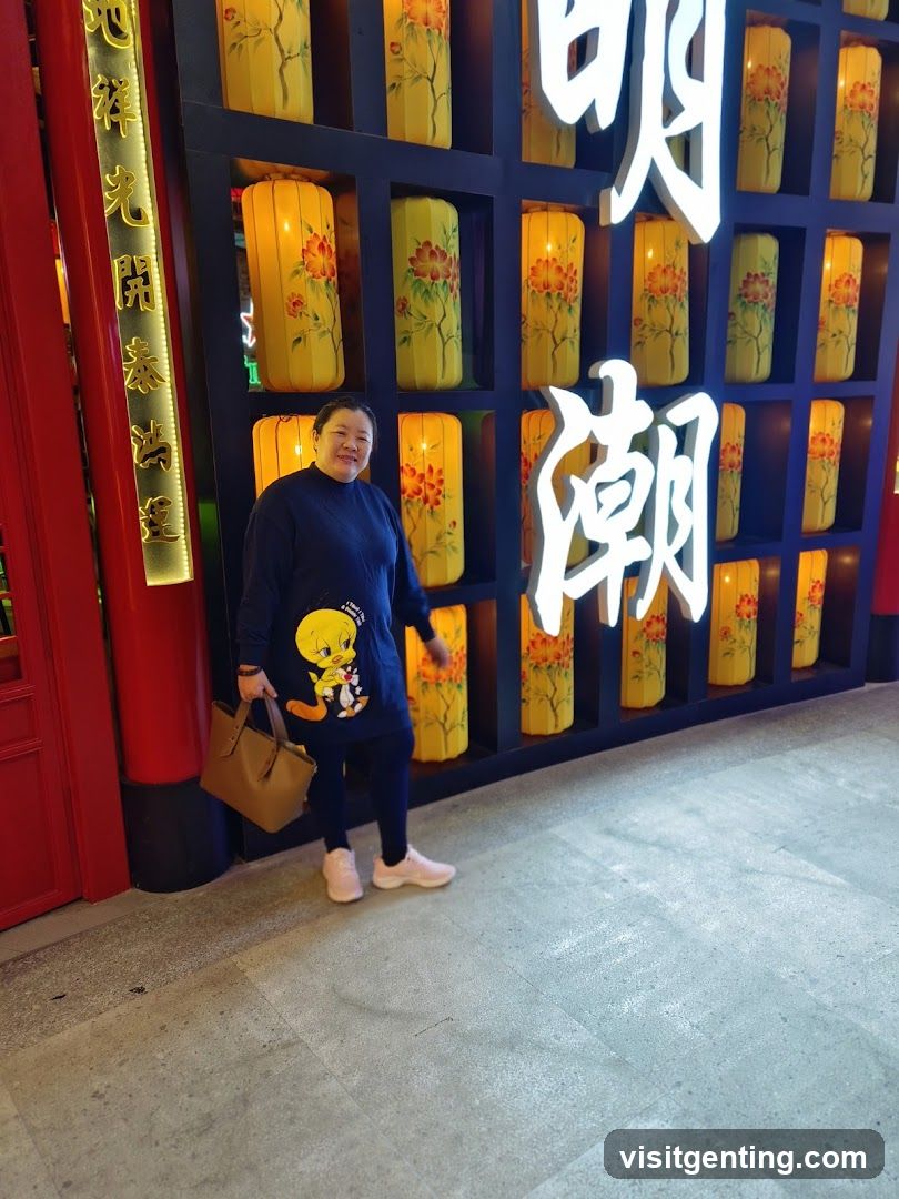 Person standing in front of decorative wall