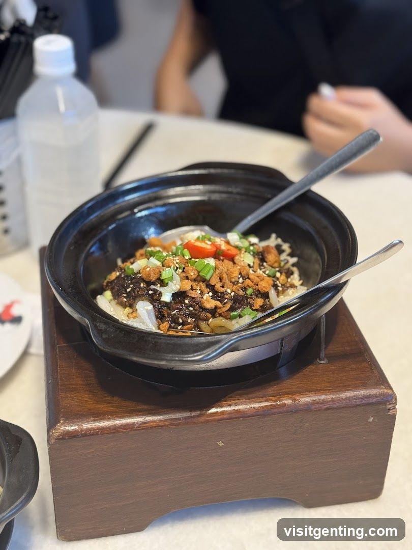 Dish served in clay pot on wooden stand
