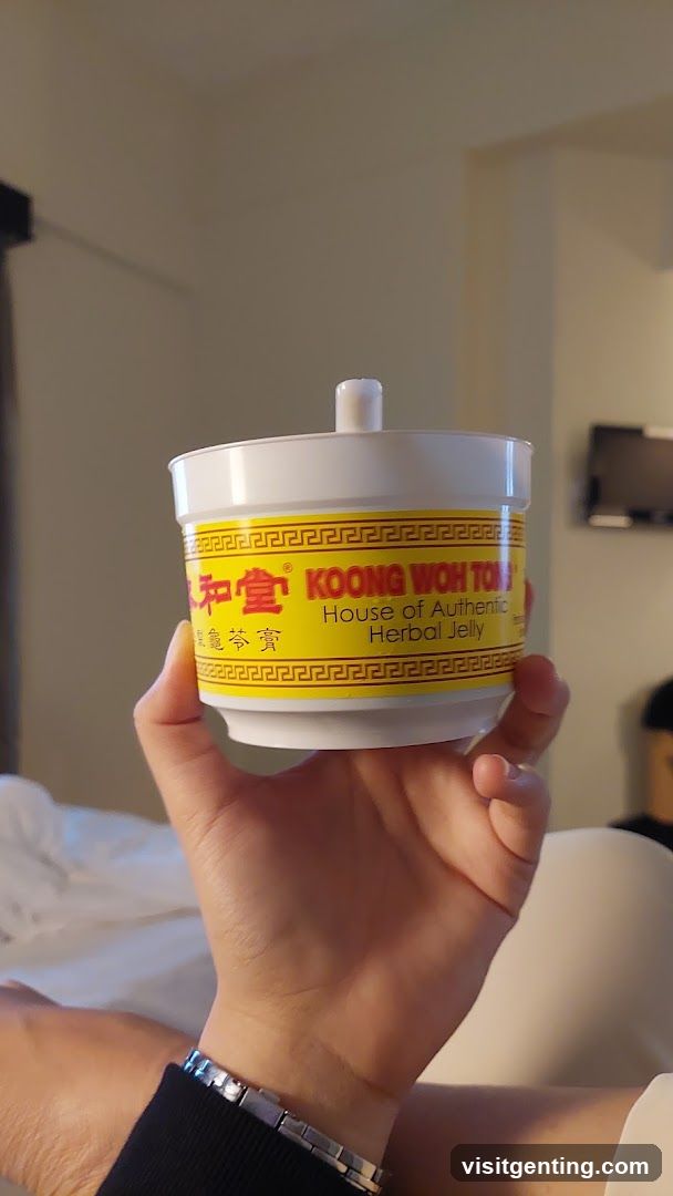 Hand holding herbal jelly container