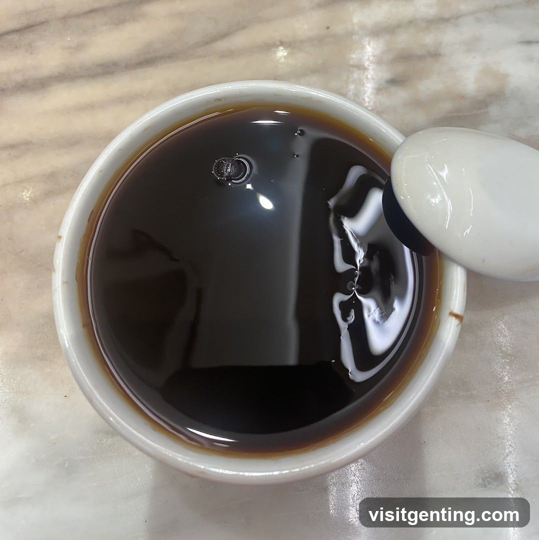 Cup of dark liquid with spoon