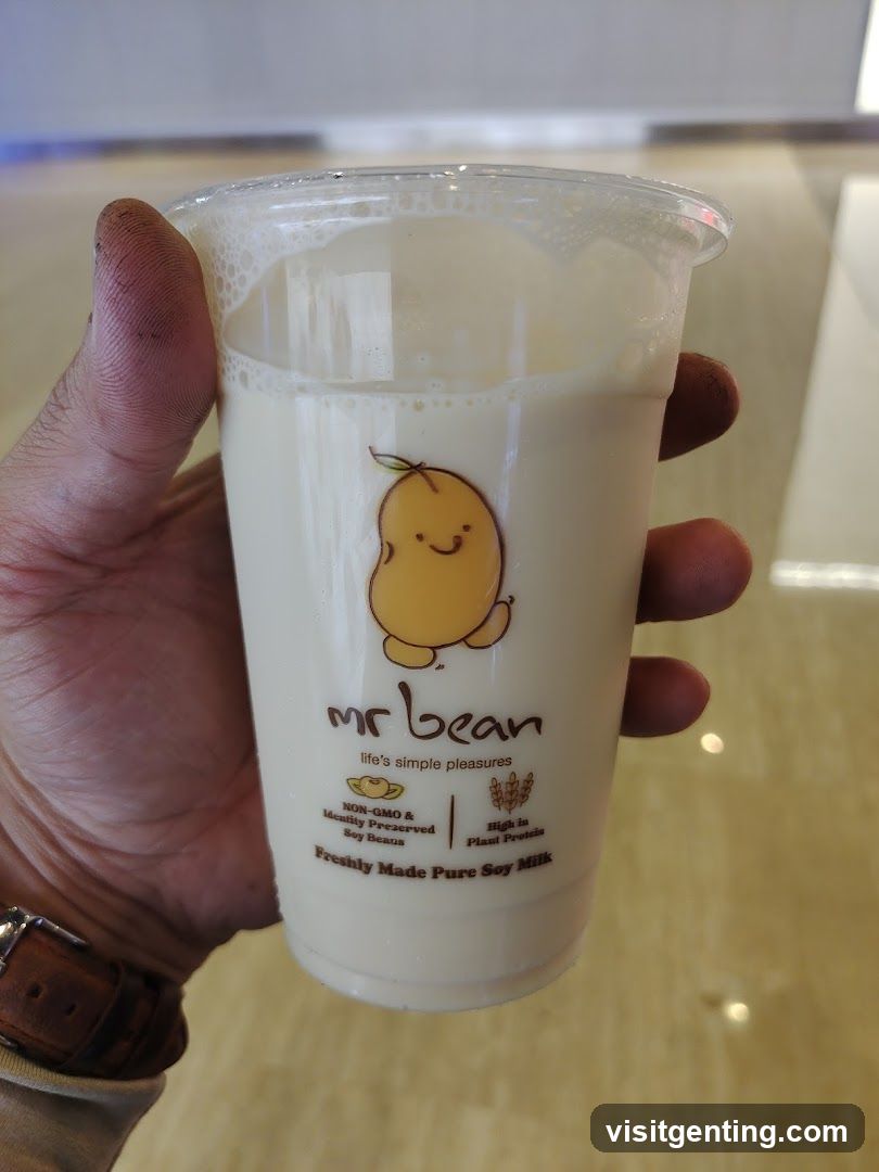 Hand holding soy milk cup