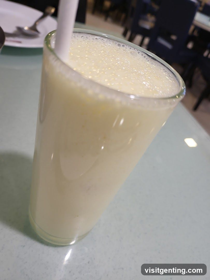 Glass of beverage with straw on table