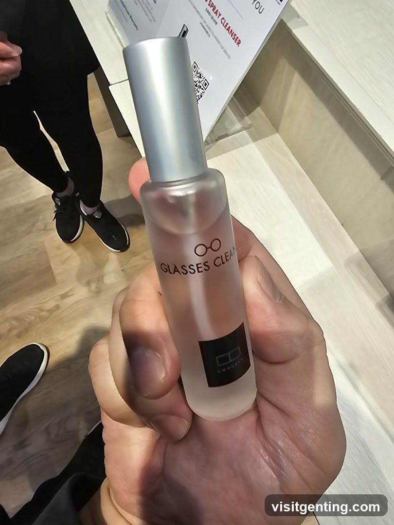 Hand holding glasses cleaner spray