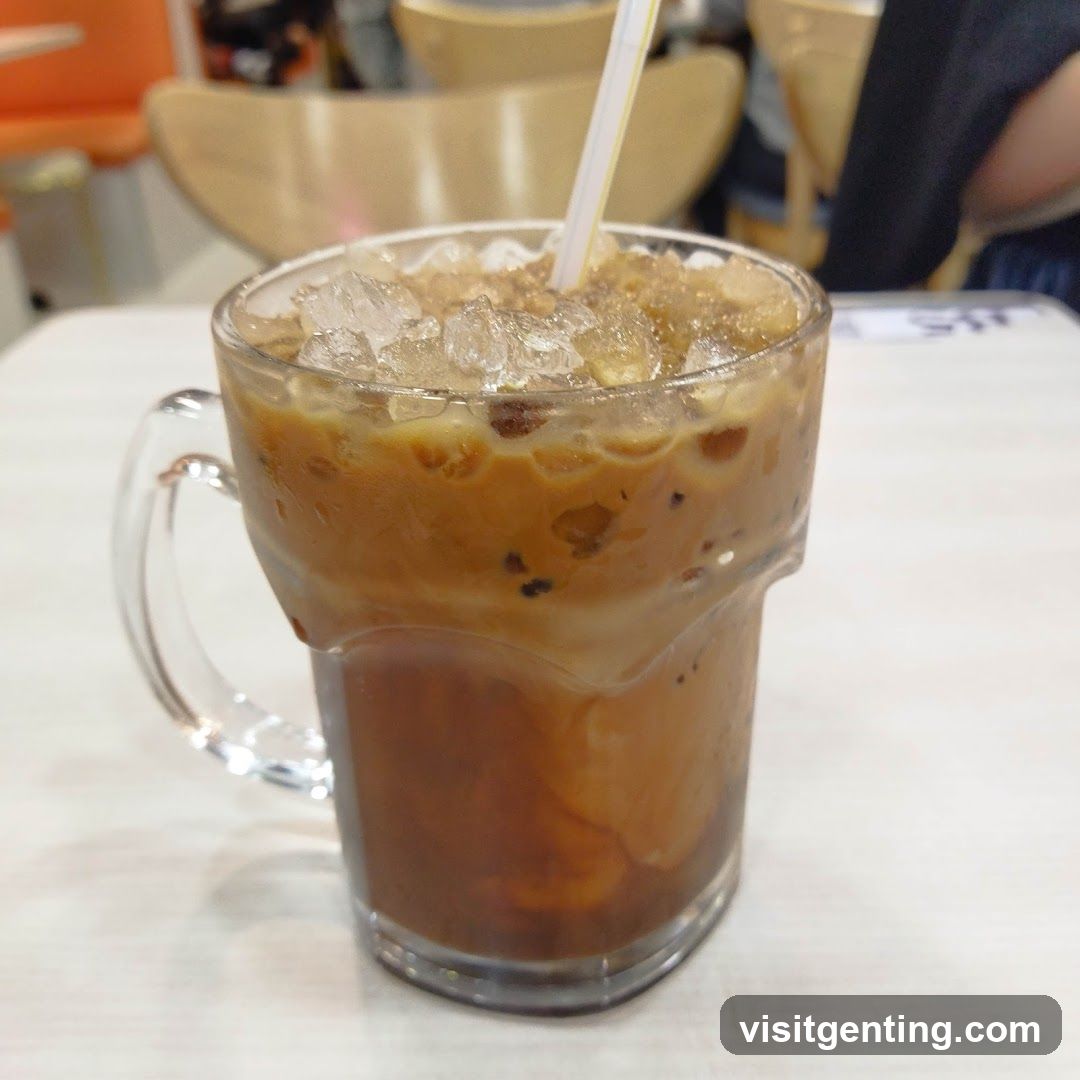 Iced coffee drink in a glass mug with straw
