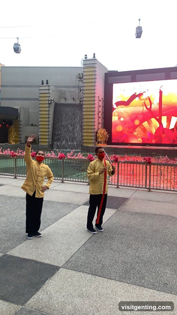 Two individuals in yellow attire posing outdoors