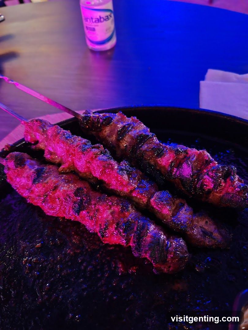 Grilled skewers on a plate under colorful lighting