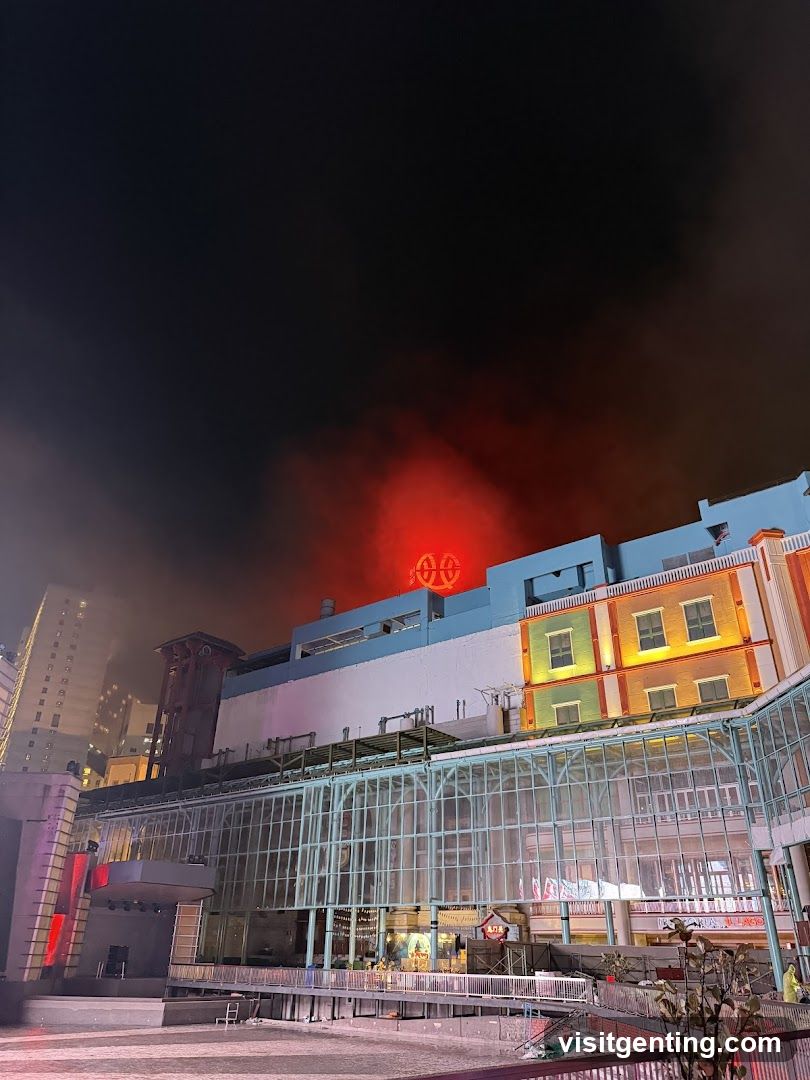 Nighttime building with smoke and red glow