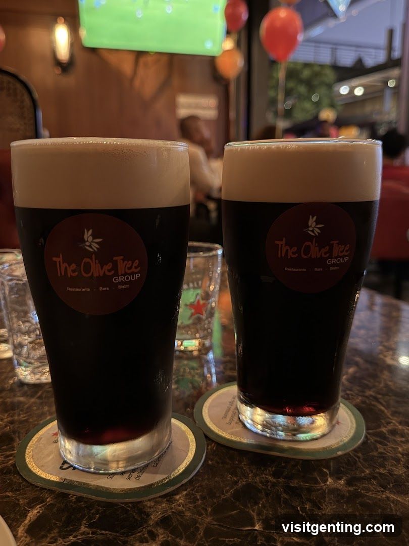 Two dark beers in branded glasses