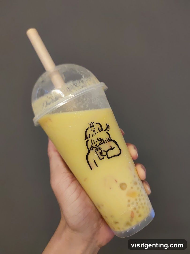 Hand holding a yellow beverage cup