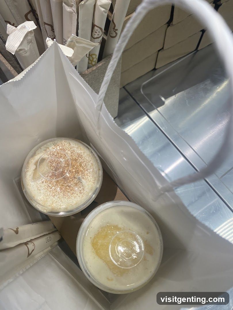 Two beverages in a white paper bag