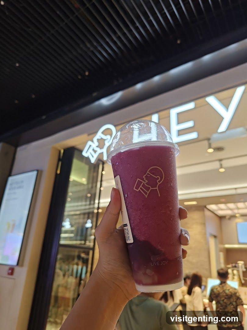 Hand holding a drink in front of a store