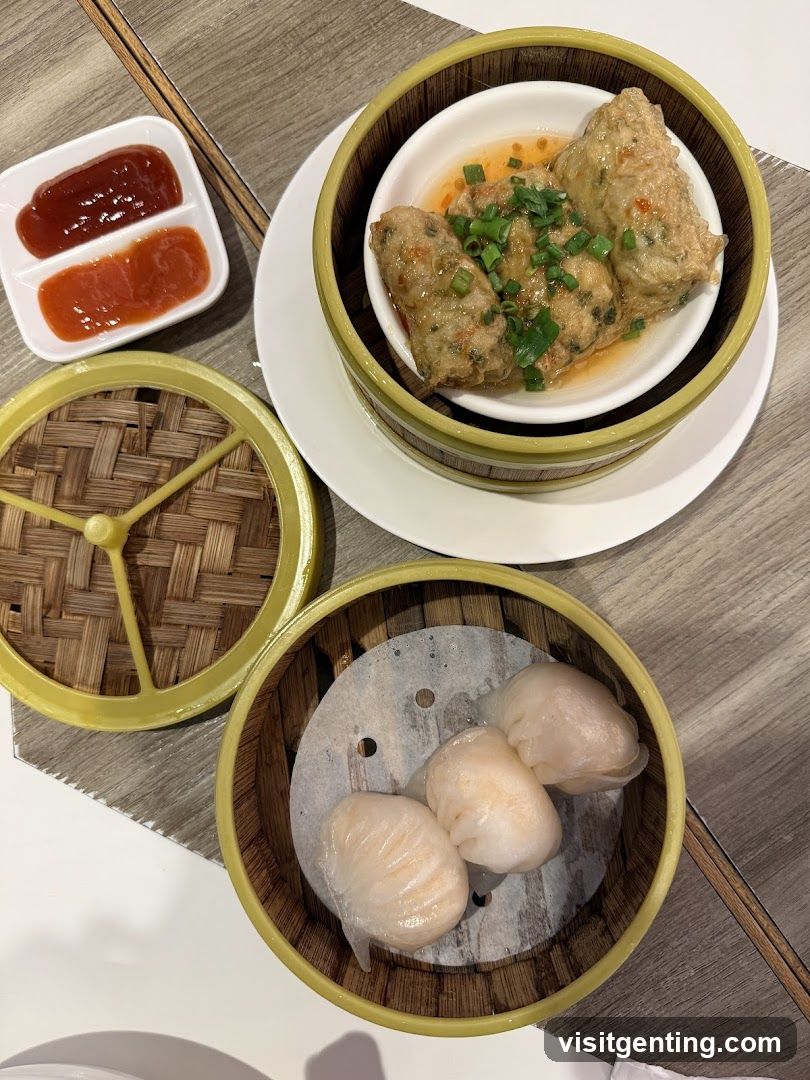 Dumplings and sauces served in bamboo steamers