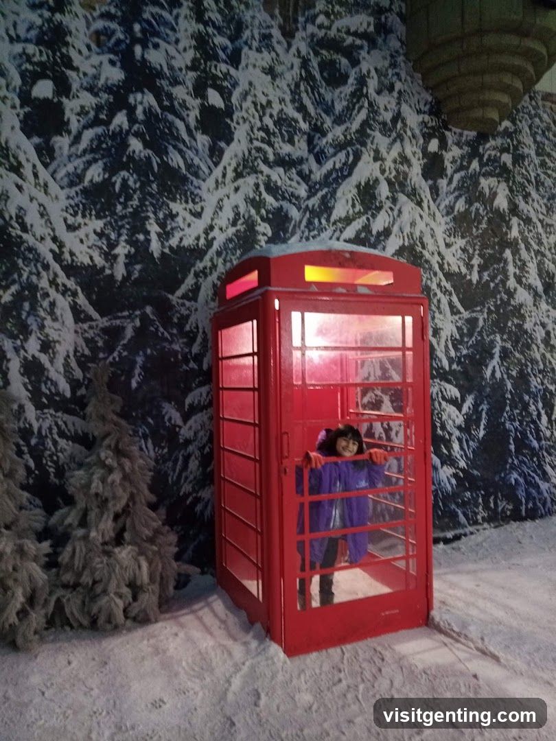 Person in Snowy Red Phone Booth