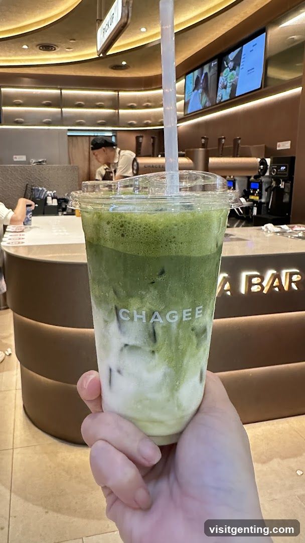 Hand holding iced matcha drink at CHAGEE