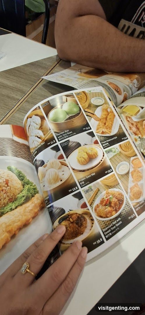 Person holding open menu at dining table