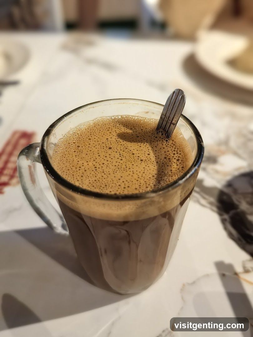 Coffee in glass mug with spoon