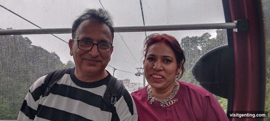 Two people in a cable car on a rainy day
