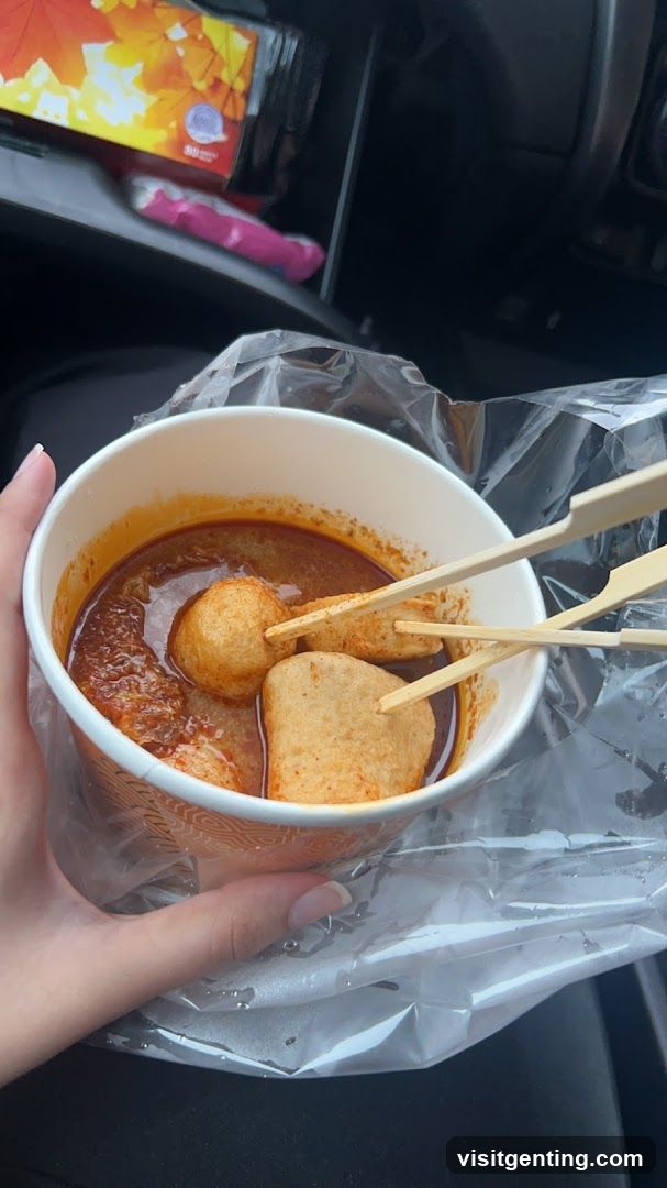 Hand holding food in car