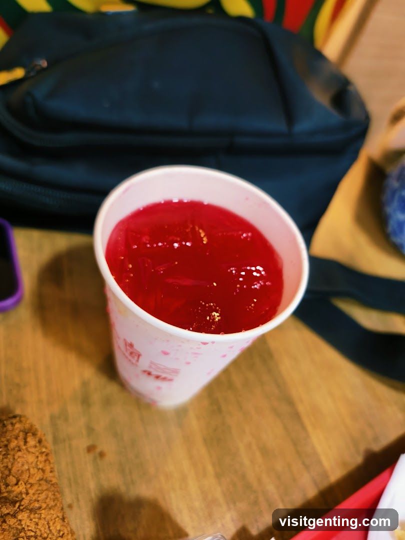 Red beverage in paper cup on wooden table