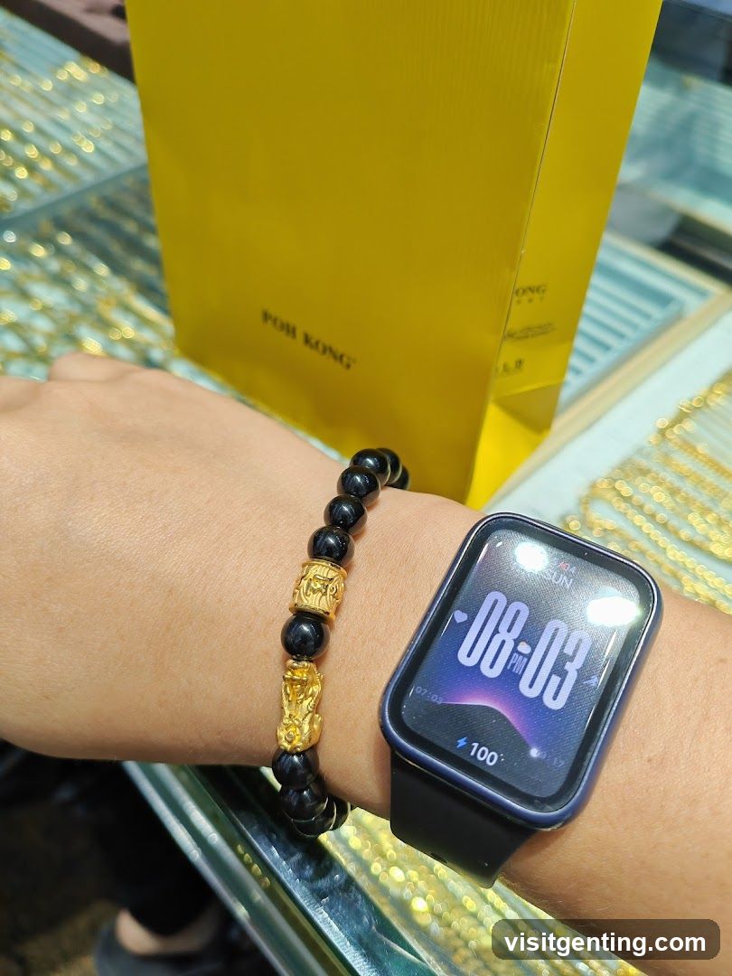 Hand wearing jewelry and smartwatch