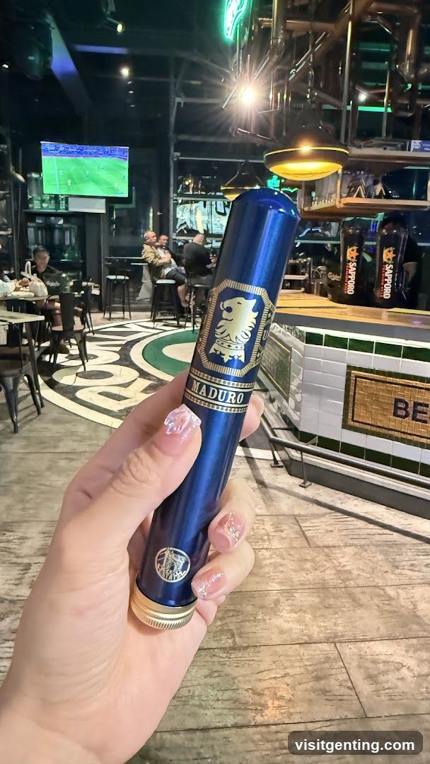 Hand holding cigar in bar interior