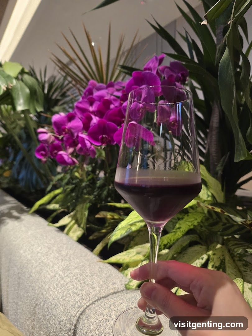 Hand holding wine glass with floral background