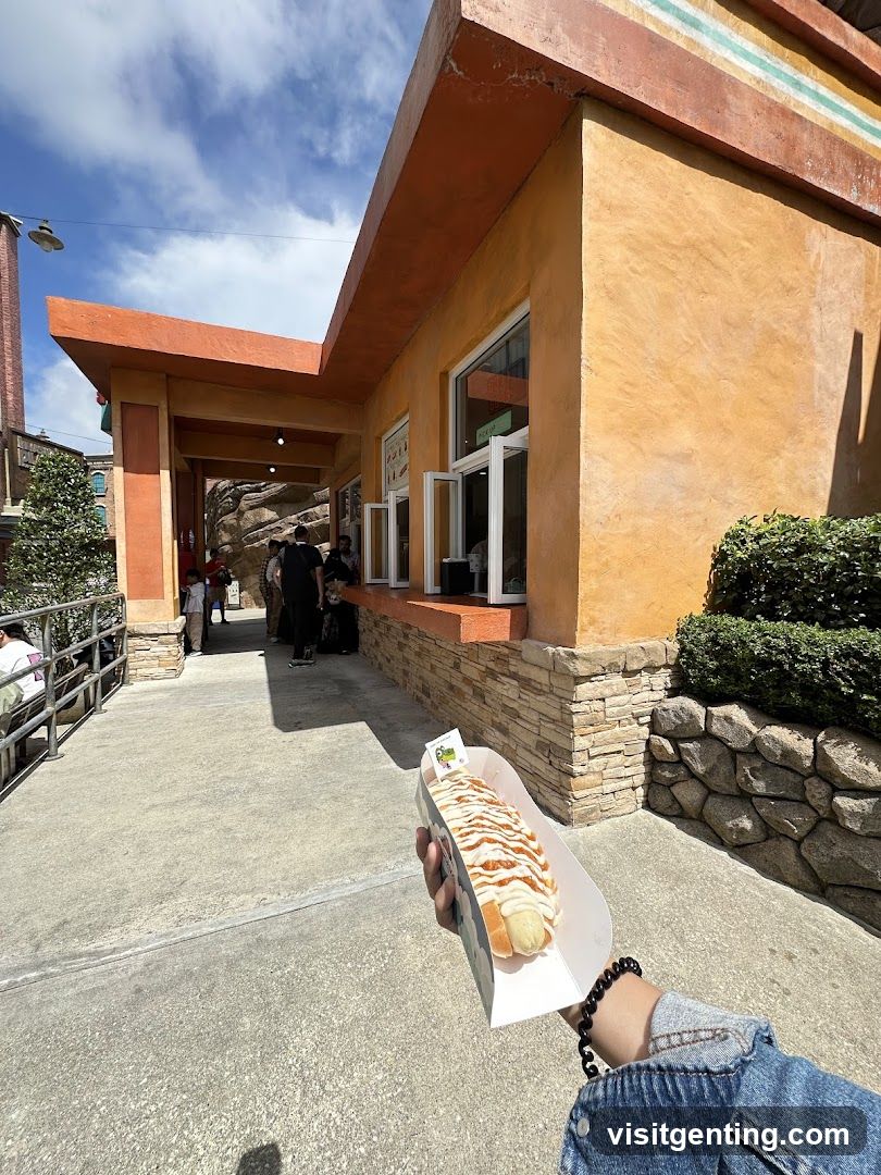 Hand holding food in front of building entrance
