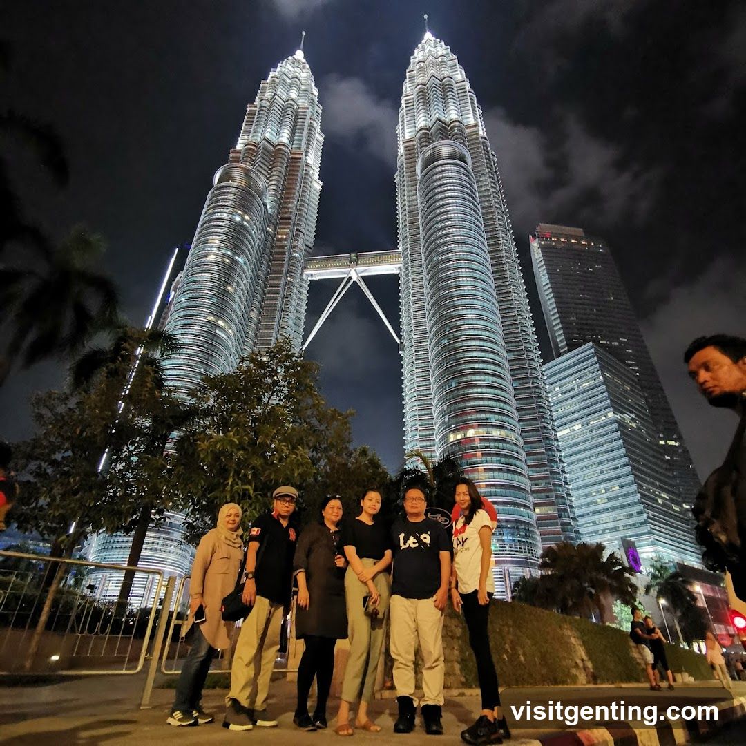 Group photo at night in front of Petronas Twin Towers