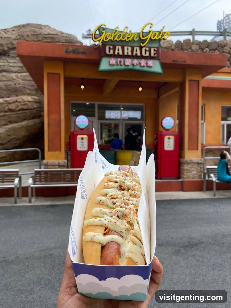 Hot dog with toppings held in front of Golden Gate Garage