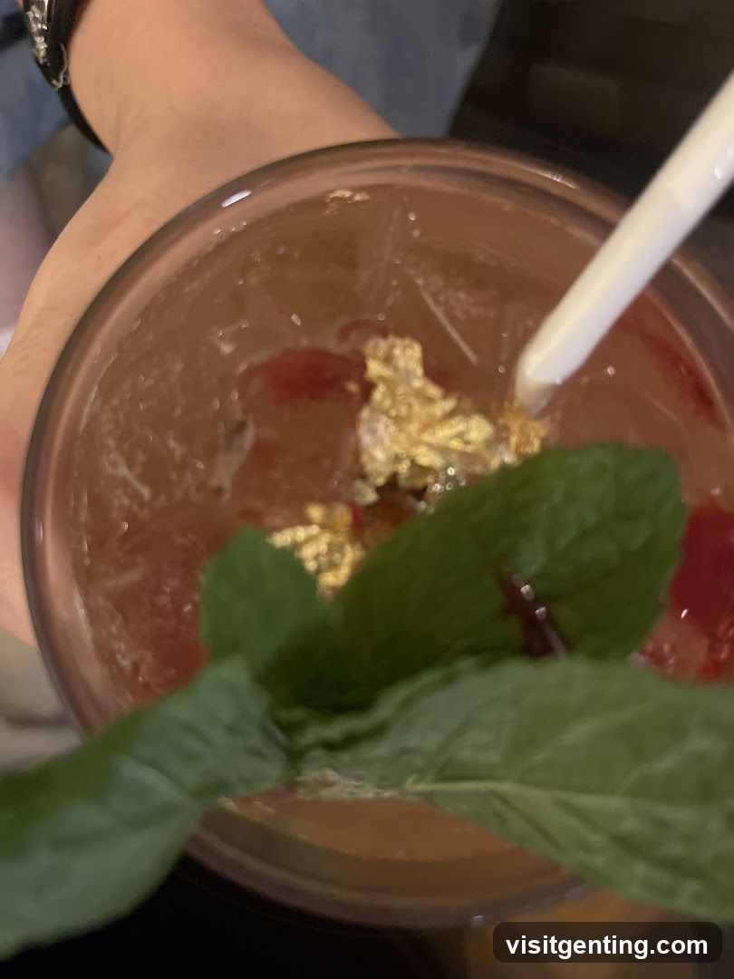 Hand holding drink with garnish