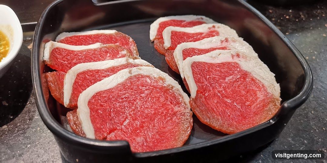 Raw meat slices in black tray
