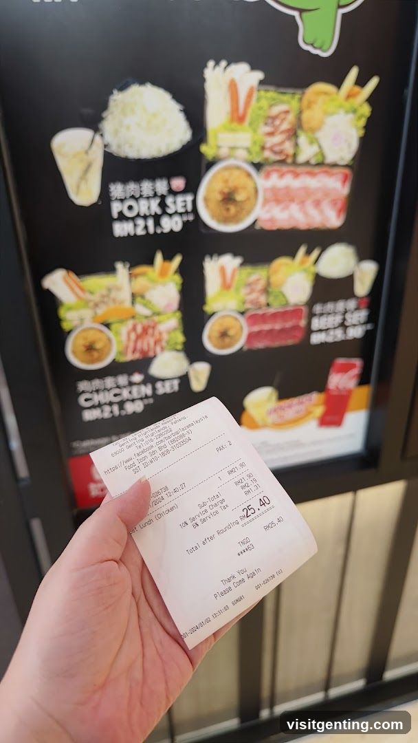 Hand holding receipt in front of food menu board