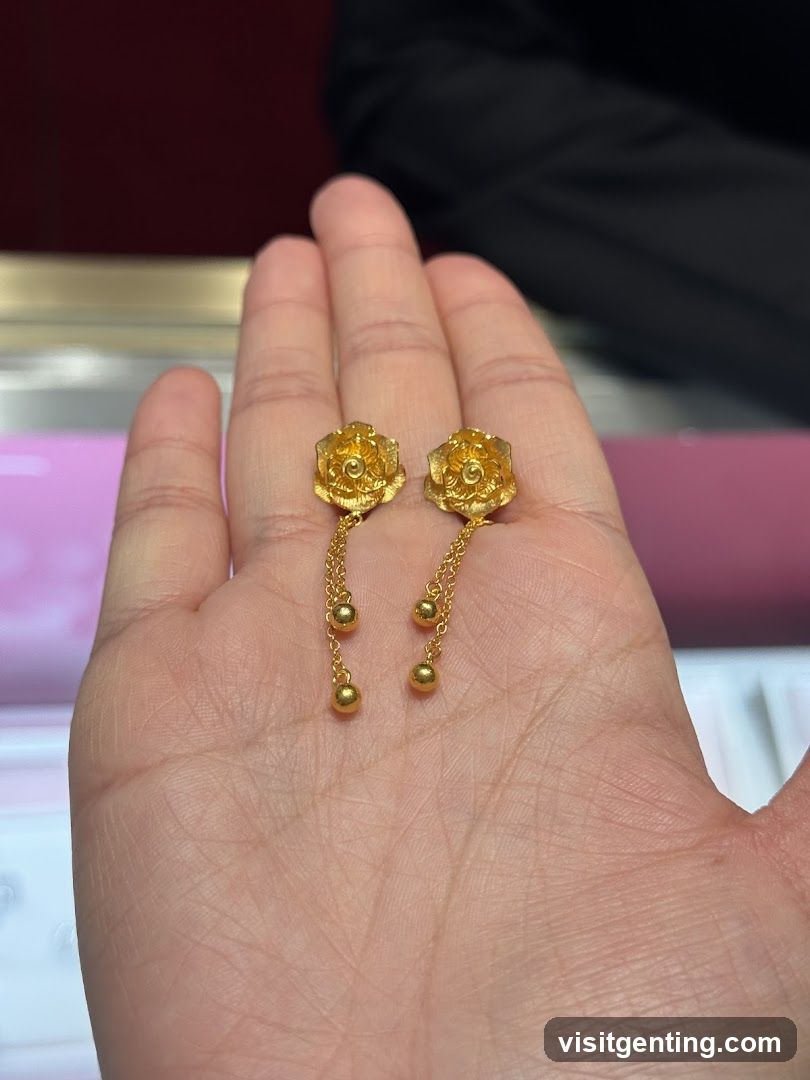 Hand Holding Gold Earrings