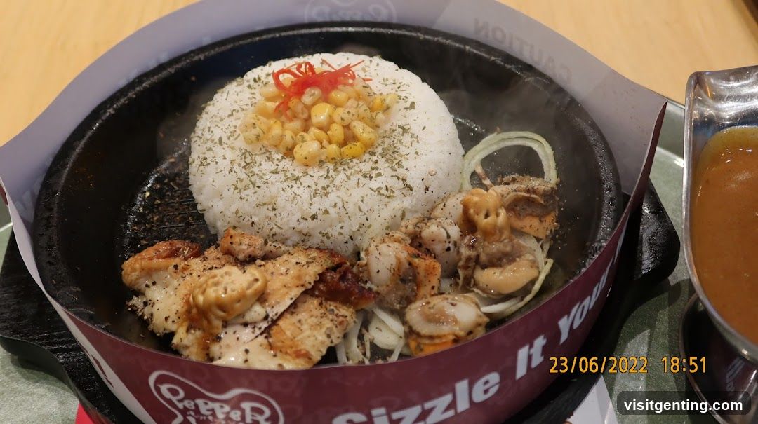 Food served in a sizzling iron skillet