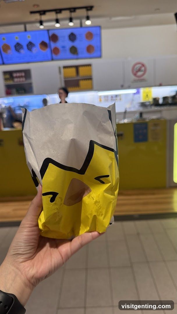 Hand holding food packaging in a store interior