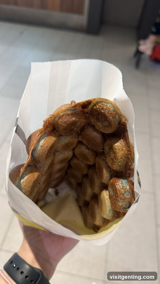 Hand holding waffle ball dessert