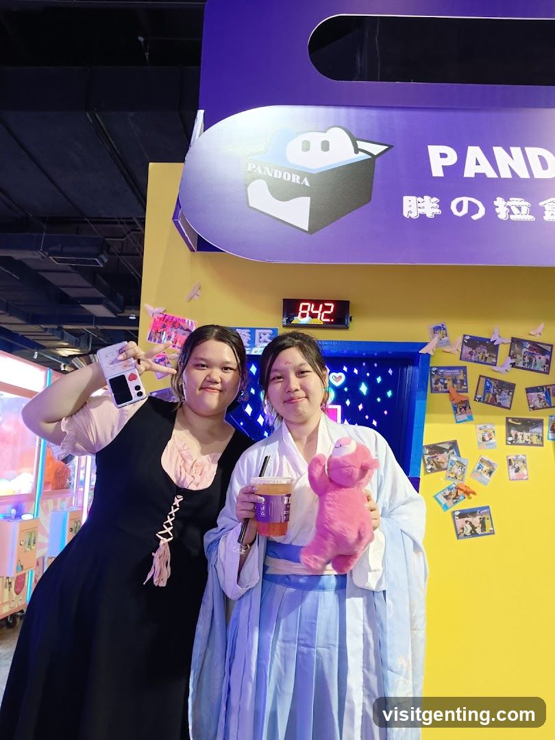 Two individuals posing in front of a branded display