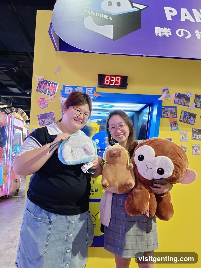Two women posing with plush toys in front of a yellow wall