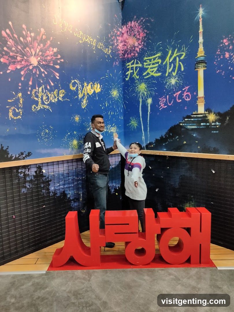 Two people posing in front of a themed backdrop