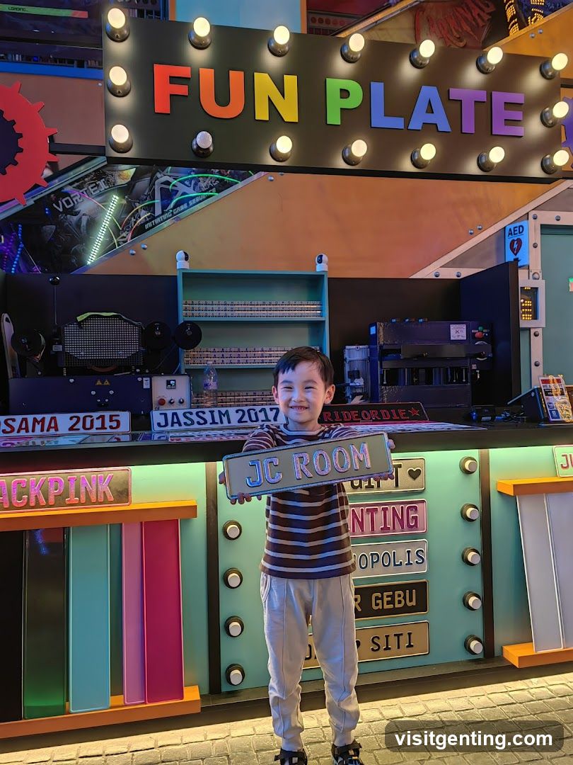 Child holding sign in front of colorful arcade-style display
