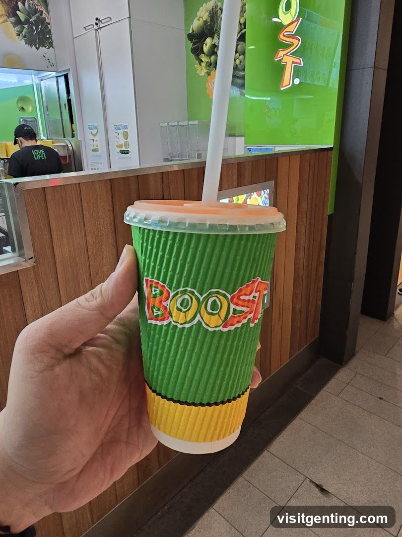 Hand holding Boost drink in store