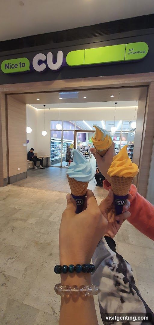 Hands holding ice cream cones in front of CU store entrance